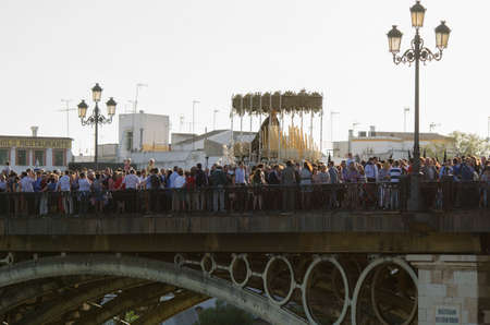 SEVILLE. SPAIN - APRIL 13: The brotherhood of La Estrella In their procession by Seville crossing...