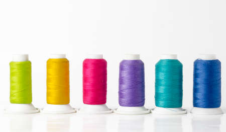 group of colorful sewing threads on white background