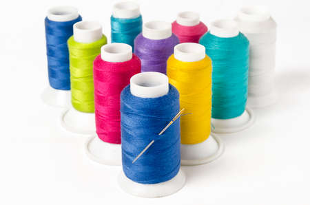 group of colorful sewing threads on white background
