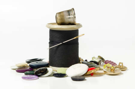 sewing utensils, thread, buttons and needle on white backgroundの写真素材