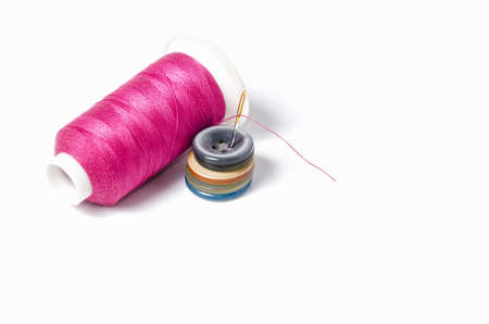 Pink thread with needle and buttons, isolated on white background