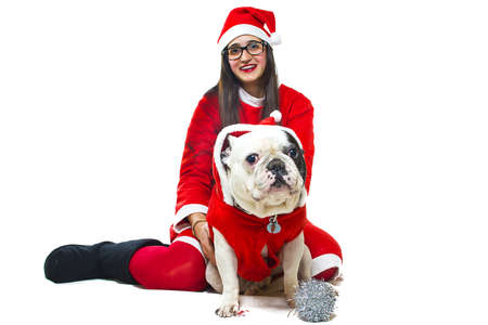 Woman and dog dressed in santa clausの写真素材