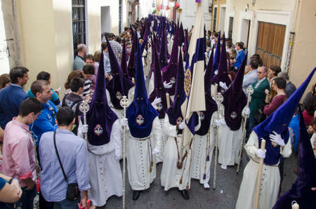 SEVILLE. SPAIN - APRIL 14: Penitents of the brotherhood of El Beso de Judas  In their procession by...
