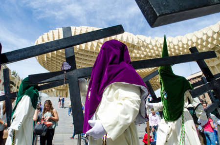 SEVILLE. SPAIN - APRIL 14: Penitents of the brotherhood of "El Beso de Judas"  In their procession by Seville, In Holy week on april 14, 2014 in sevilleのeditorial素材