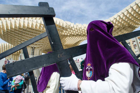 SEVILLE. SPAIN - APRIL 14: Penitents of the brotherhood of "El Beso de Judas"  In their procession by Seville, In Holy week on april 14, 2014 in sevilleのeditorial素材