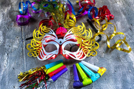 Carnival mask with colorful streamers and party blowersの写真素材