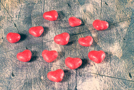 Candy hearts on wooden background