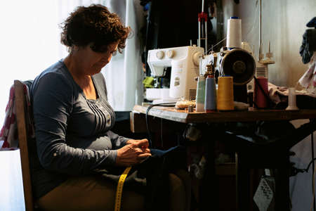 Middle aged woman sewing