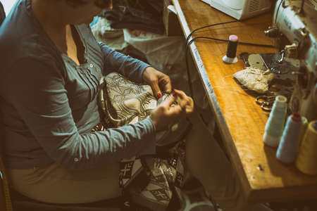 Middle aged woman sewingの写真素材