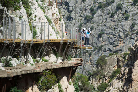 ARDALES (MALAGA), SPAIN - APRIL 17: Tourists walk along the 'El Caminito del Rey' (King's Little Path), World's Most Dangerous Footpath reopened in May 2015 a safer footpath was installed above the original. On apr 17, 2015 in Ardales (Malaga, Spain).のeditorial素材