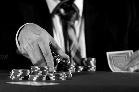 Man betting on the casino in black and whiteの写真素材