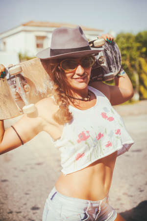 Sexy woman with Skateboard and analog film effectの写真素材