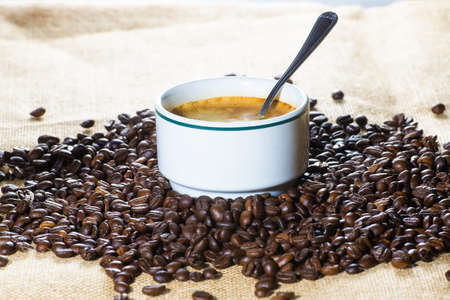 Cup of coffee and coffee beans in sack