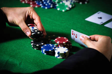 Man in casino with couple of ace and king