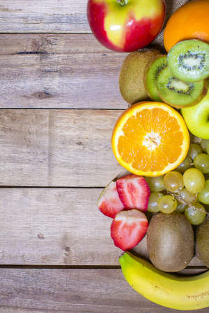 Mixed fresh fruits on old wooden background.の写真素材