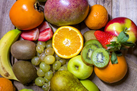 Mixed fresh fruits on old wooden background.の写真素材