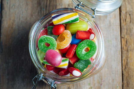 Colorful candy gum on old wooden table.の写真素材
