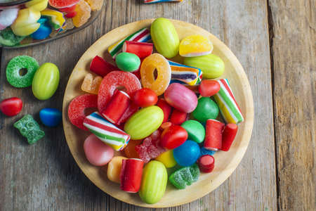 Colorful candy gum on old wooden table.の写真素材