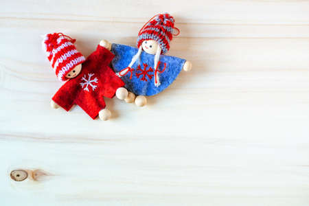 Couple of christmas dolls on wooden background.の写真素材