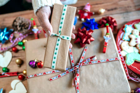 Close-up of hands with Christmas gifts.の写真素材