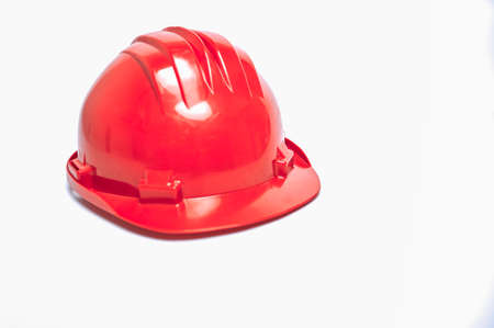 Red workman's helmet on white background