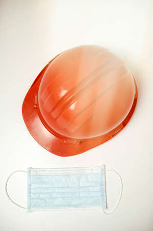 Workman's helmet next to antiviral maskの写真素材