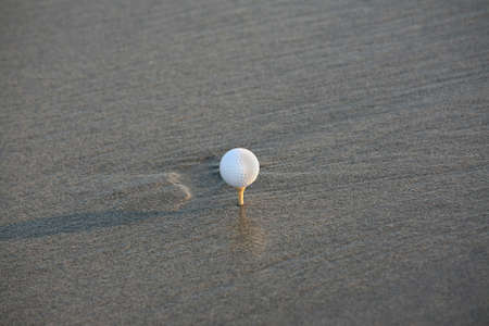 golf ball in the sandの写真素材