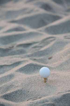 golf ball in the sand portraitの写真素材