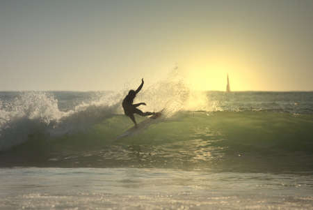 sunset surfer in the waveの写真素材