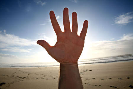 open hand with five fingers on blue sky