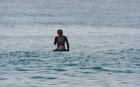 surfer seated in the board