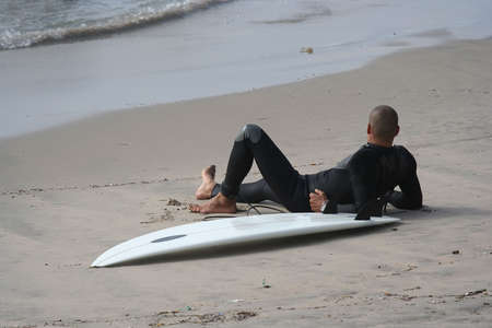 surfer rest in the sandの写真素材