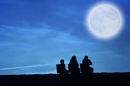 family looking to the moonの写真素材