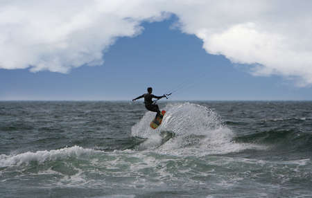 kitesurfer flying over the waveの写真素材