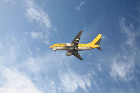 yellow aeroplane in a blue skyの写真素材