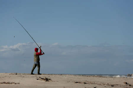 fisherman in the beach with blue skyの写真素材