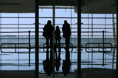 family looking through the window in the airportの写真素材