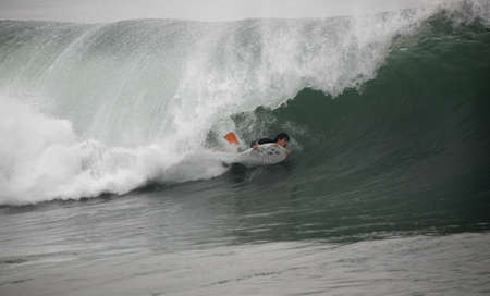 photo of a bodyboarder in the tunnelの写真素材