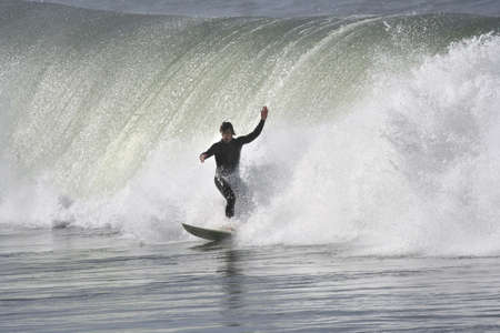 surfer with a big wave in the back