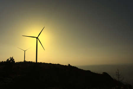 sunset photo of wind turbines の写真素材
