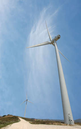 photo of a road with wind turbines