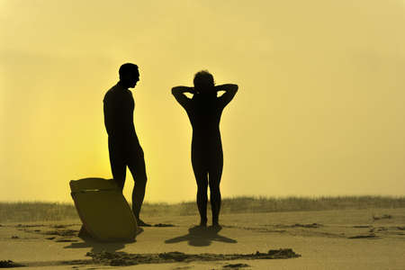 photo of two bodyboarders at sunsetの写真素材