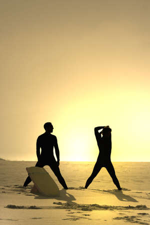 photo of two bodyboarders at sunsetの写真素材