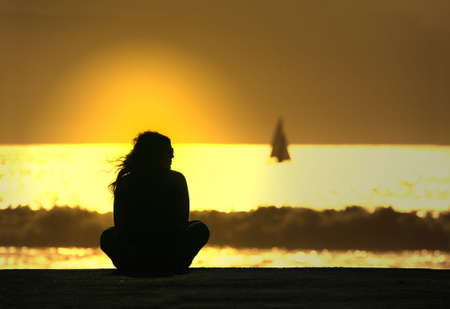 girl in meditation at sunsetの写真素材