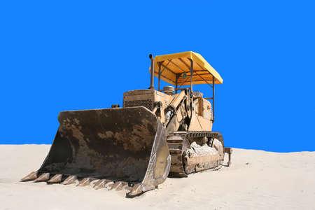 bulldozer in the sand with blue backgroundの写真素材