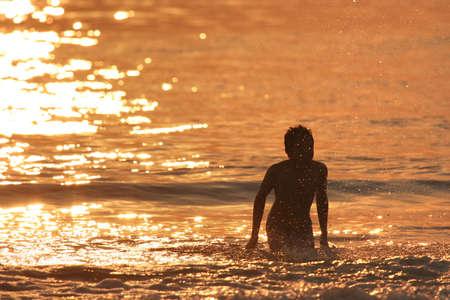 boy in the at sunsetの写真素材