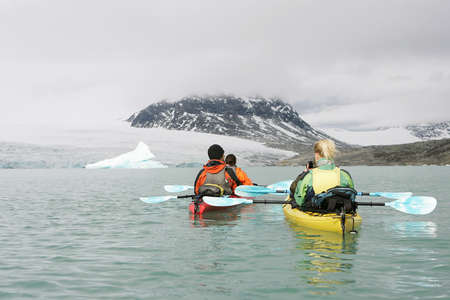 two couples kayaking in norwayの写真素材