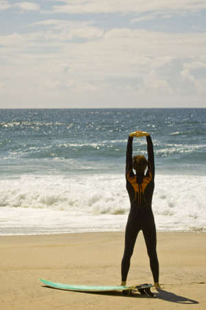 surfer warming up n the beachの写真素材