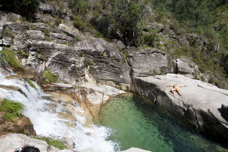 waterfall with trees and transparent waterの写真素材