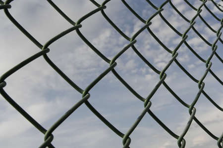 blue sky behind an restrictive grid